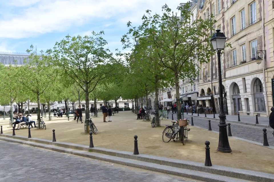Place Dauphine plaza in Paris, France with parked bikes and people milling around.